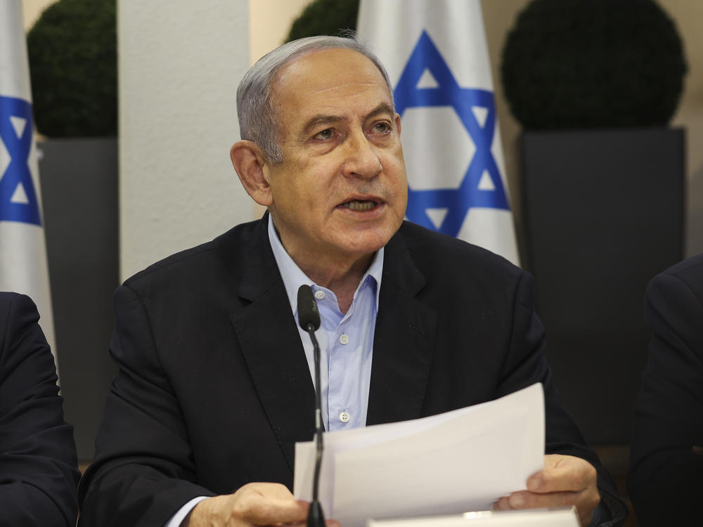 Israeli Prime Minister Benjamin Netanyahu, centre, speaks during the weekly cabinet meeting at the Defence Ministry in Tel Aviv, Israel, Sunday Jan. 7, 2024.