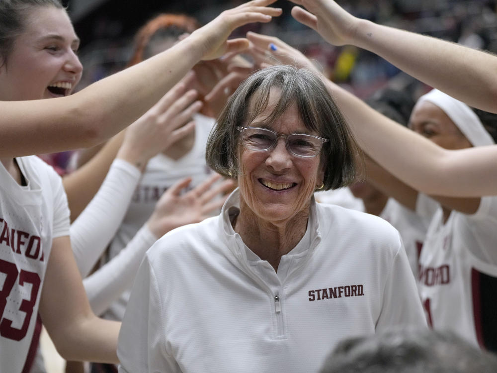 Stanford coach Tara VanDerveer smiles as players celebrate her 1,202nd victory as a college coach, against Oregon in an NCAA basketball game Friday, Jan. 19, 2024, in Stanford, Calif.