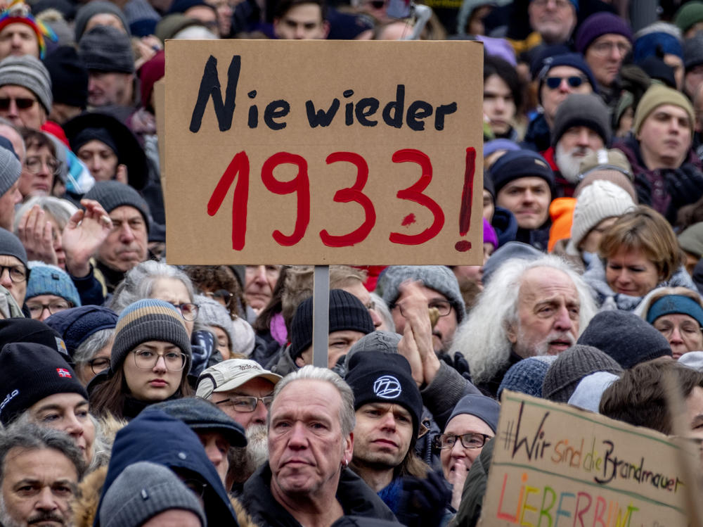 People gather as they protest against the AfD party and right-wing extremism in Frankfurt/Main, Germany, Saturday, Jan. 20, 2024. Sign reads 