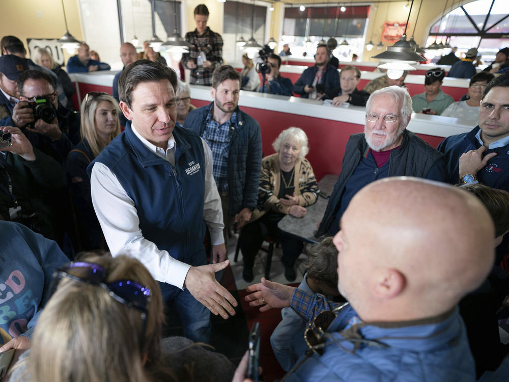 Republican presidential candidate Florida Gov. Ron DeSantis greets people during a campaign event at The Drive-In on Saturday in Florence, S.C.