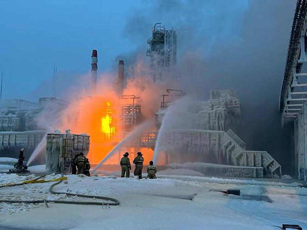 In this photo released by Telegram Channel of Leningrad Region Governor Alexander Drozdenko fire fighters extinguish the blaze at Russia's second-largest natural gas producer, Novatek in Ust-Luga port, 165 kilometers southwest of St. Petersburg, Russia, Sunday, Jan. 21, 2024. Local media reported that the port had been attacked by Ukrainian drones, causing a gas tank to explode.
