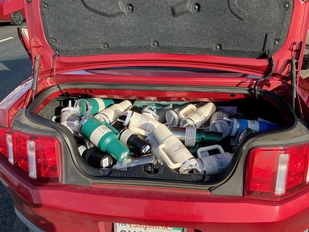 The department released photos from the traffic stop showing a trunk full of the cups.