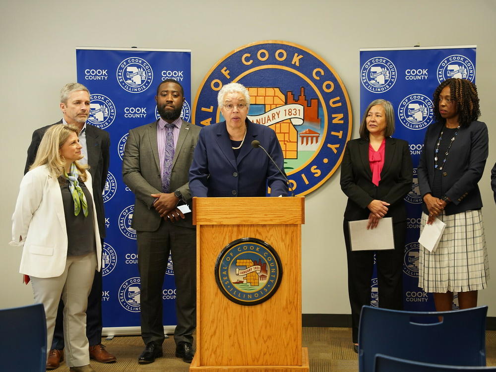 Cook County board president Toni Preckwinkle (center) announces the county's debt relief program, along with executives from several local hospitals and Allison Sesso, President & CEO of RIP Medical Debt (far left).