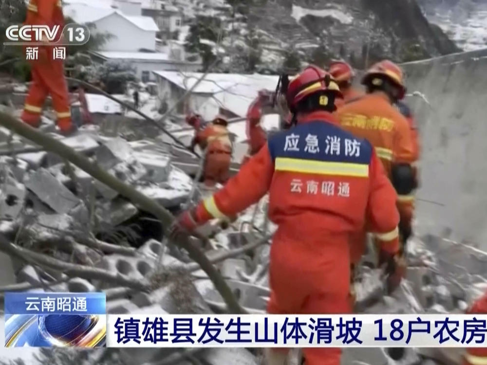 In this image taken from video footage run by China's CCTV, rescue workers search through rubbles in the aftermath of a landslide in liangshui village in southwestern China's Yunnan Province on Monday, Jan. 22, 2024.