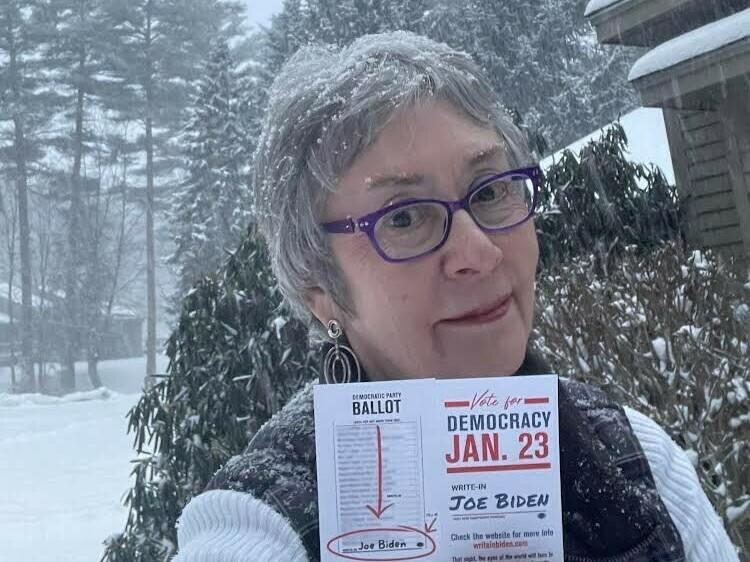 Stephanie Harris of Claremont, N.H., holds instructions she had made at her local print shop about how to write in Biden's name on New Hampshire's Democratic primary ballot.