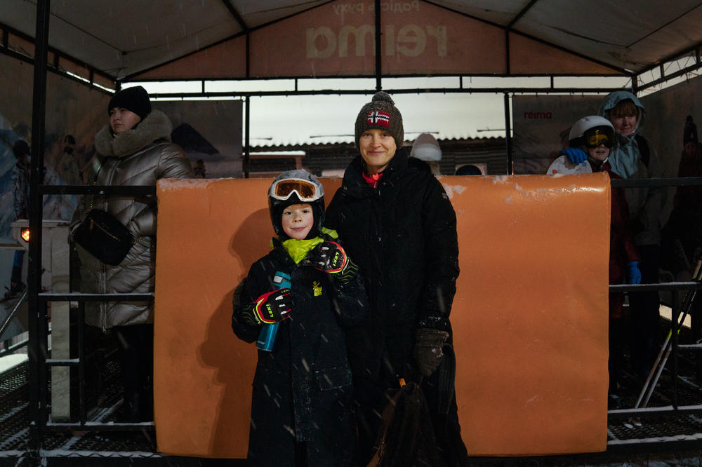Ivan Kovaliov, 9, and his mother, Kateryna Ponomarenko, pose for a photo at the bottom of the ski slope.