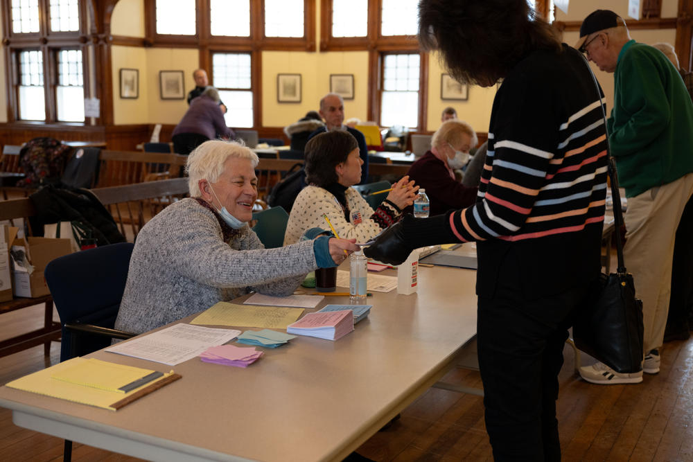 Nancy Campbell, 71, a ballot clerk at the Dublin Town Hall polling place, helps a voter on Tuesday, Jan. 23, 2024, in Dublin, N.H.