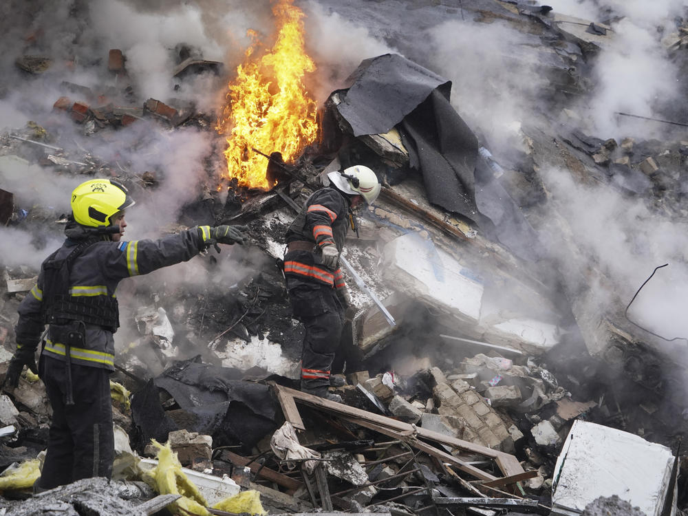 Rescuers work the scene of a building damaged by Russian rocket attack in Kharkiv, Ukraine, Tuesday, Jan. 23, 2024.