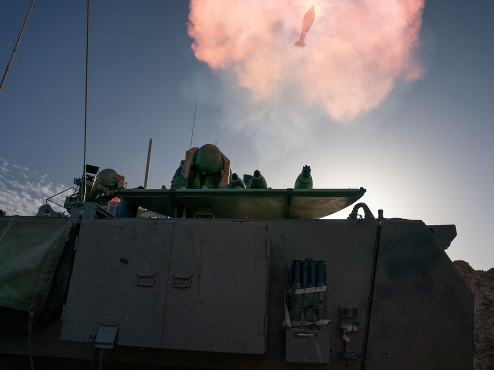Israeli soldiers prepare and fire mortars from inside Israel into Gaza, backing up troops near the Maghazi refugee camp on Monday.