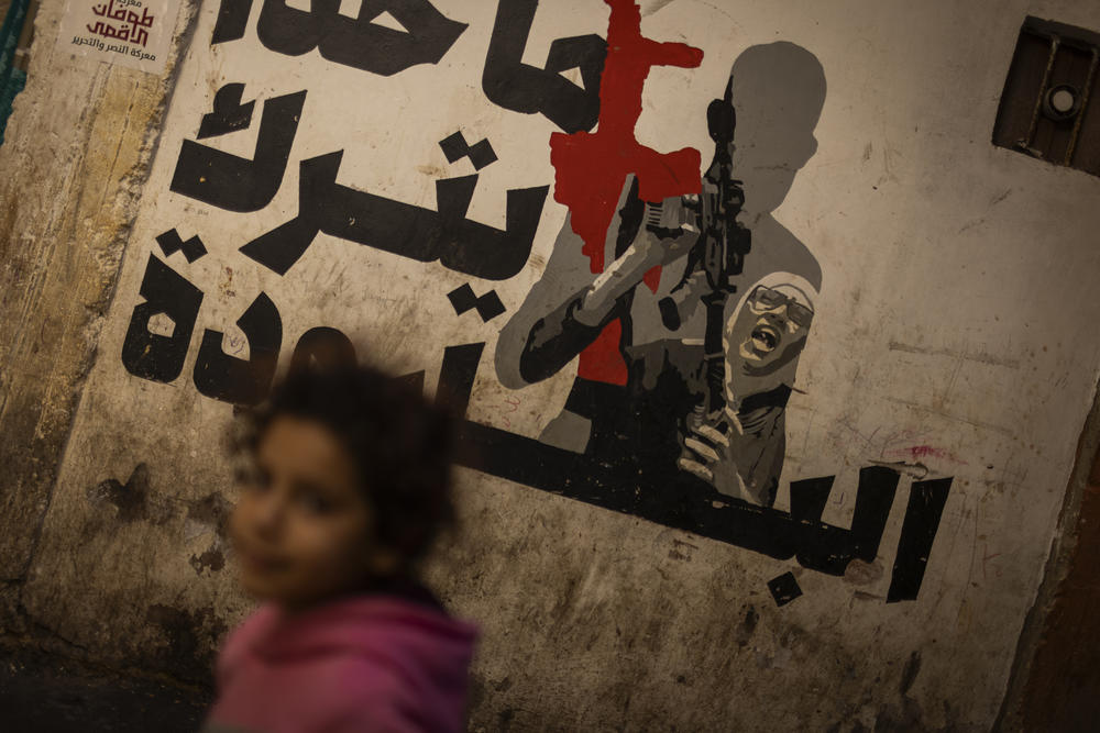A young Palestinian girl walks through the streets of the crowded Shatila refugee camp.