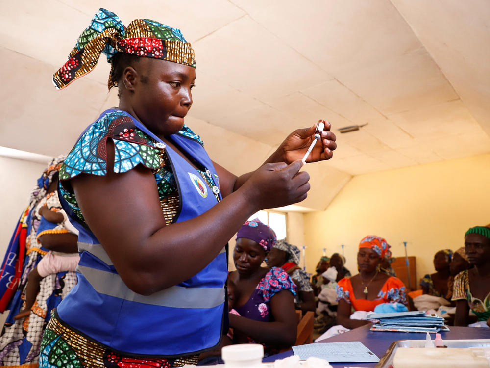A nurse prepares to administer a newly approved malaria vaccine, RTS,S, to an infant at the health center in Datcheka, Cameroon, on Jan. 22. Cameroon is the first country in the vaccine campaign. Plans are to introduce the vaccine in 20 additional countries by 2025.