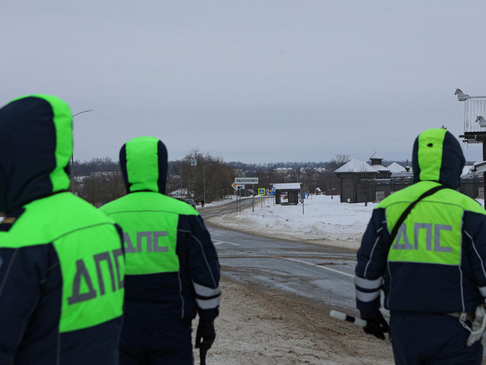 Traffic police officers block off a road near the crash site of the Russian Ilyushin Il-76 military transport plane outside the village of Yablonovo in Russia's Belgorod region on Wednesday.