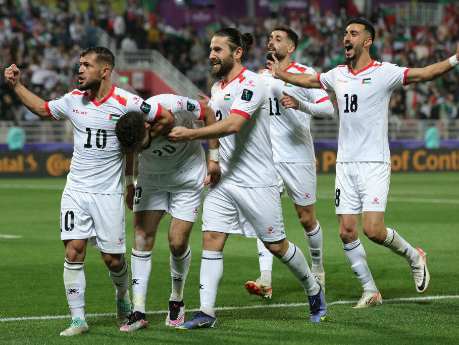 Players from the Palestinian soccer team celebrate their second goal in its 2023 AFC Asian Cup match with Hong Kong.