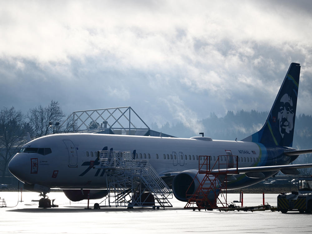 Alaska Airlines N704AL, a Boeing 737 Max 9, which made an emergency landing at Portland International Airport on January 5 is parked at a maintenance hanger in Portland, Ore. on January 23, 2024. One of two door plugs on the emergency exit door blew out shortly after the plane took off from Portland.