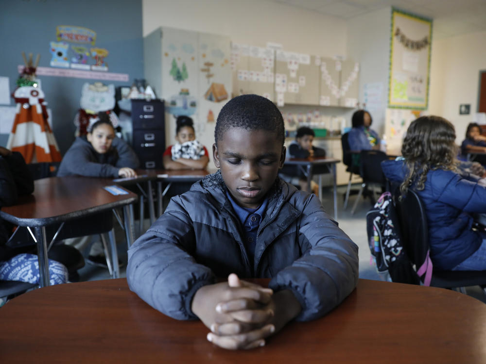 A student named Royce closes his eyes during a mindfulness session in class at Patricia J. Sullivan Partnership School in Tampa, Fla. Students say the daily lessons help them cope with their feelings.