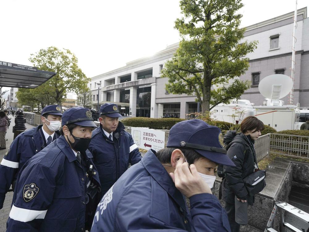 Police officers gather outside the Kyoto District Court in Kyoto, western Japan, Thursday, Jan. 25, 2024, ahead of the sentencing hearing for Shinji Aoba.