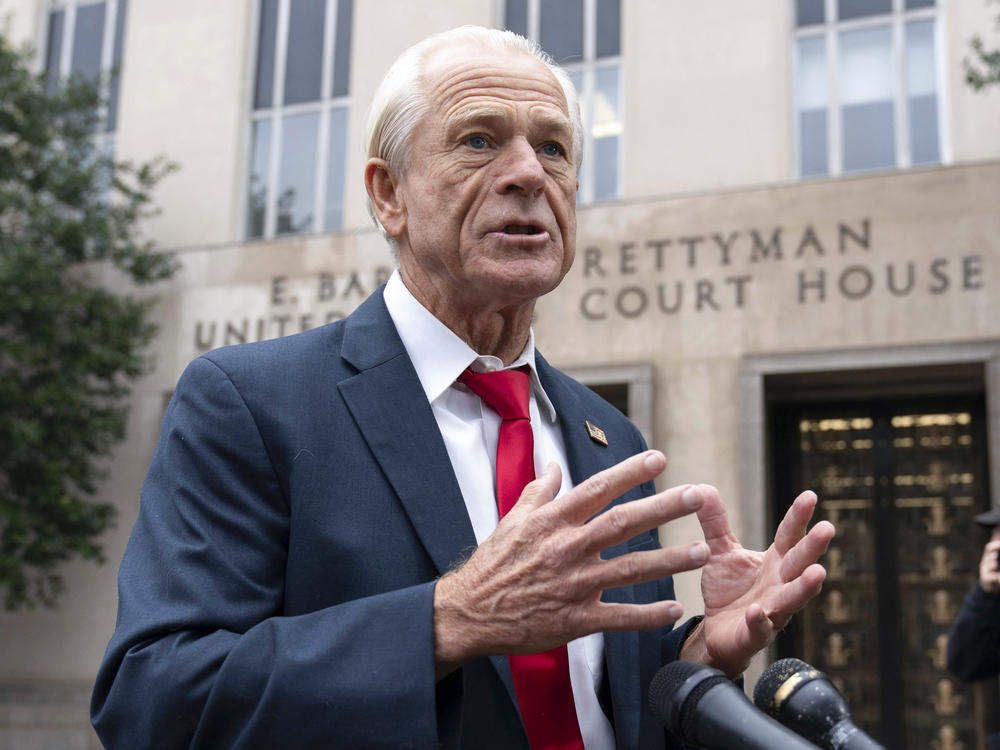 Former Trump White House official Peter Navarro talks to the media as he arrives at U.S. Federal Courthouse in Washington on Thursday.