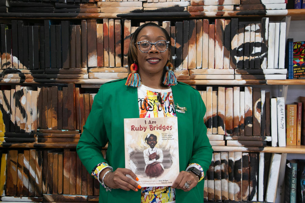 Brittni Robertson Powell, with the bookstore Baldwin & Co. in New Orleans, holds her pick, I Am Ruby Bridges.