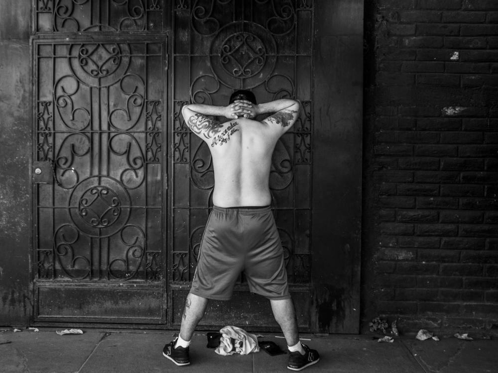 A man with tattoos waits to be interrogated by soldiers on Dec. 3, 2022. According to human rights organizations, having tattoos was the reason many were arrested during the first days of the country's state of emergency.