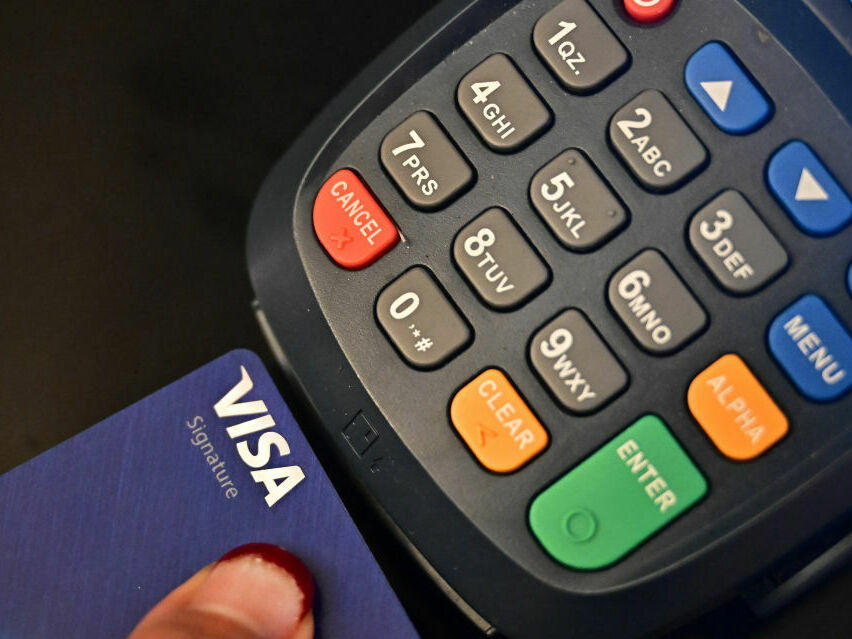 A credit card is placed into a machine for processing payments on Sept. 11 in La Puente, Calif.