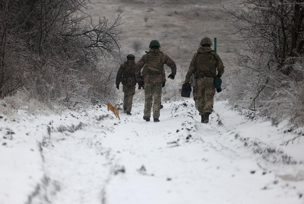 Ukrainian soldiers walk along a road not far from the Russian-occupied Ukrainian city of Bakhmut, Donetsk region, on Dec. 13.