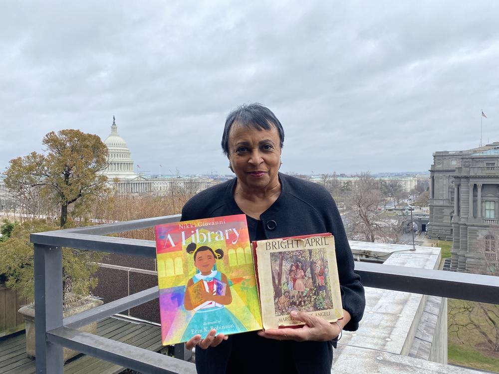 Dr. Carla Hayden, the nation's Librarian of Congress, holds her picks for Black History Month reading: <em>A Library</em> and <em>Bright April.</em>