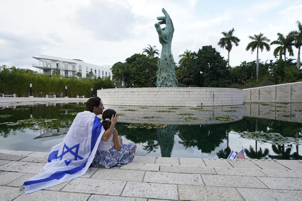 Elinor Ben David (left) hugs her daughter Liel Abissidan, 8, as they wait for a rally in support of Israel to start, at the Holocaust Memorial Miami Beach on Oct. 10, 2023, in Miami Beach, Fla.