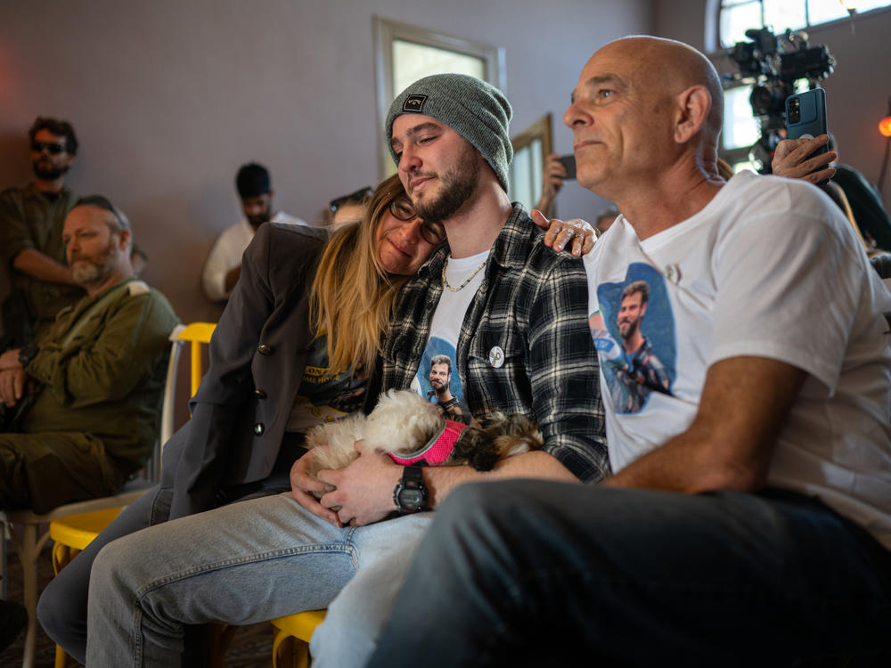 Idit (from left), Ronen and Kobi Ohel â mother, brother and father of Alon Ohel â listen to the concert.