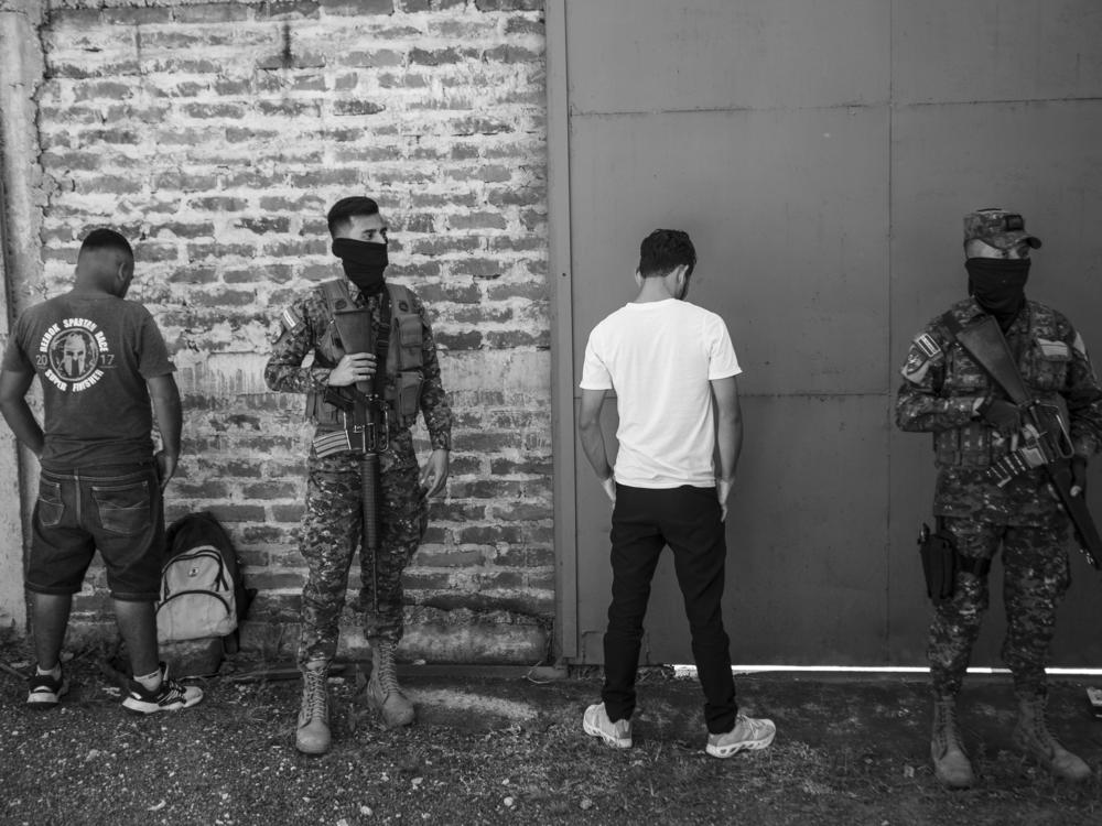 Young people are arrested by security forces patrolling Soyapango during a crackdown against gangs on Dec. 3, 2022.