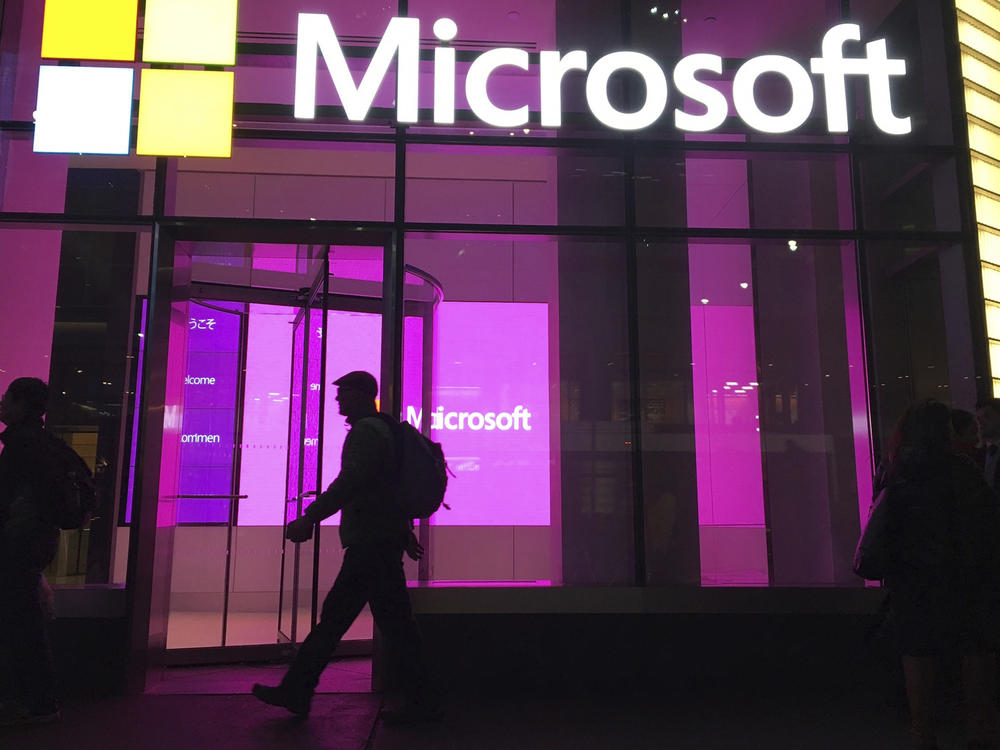 People walk past a Microsoft office in New York in 2016. Big Tech companies, like Google and Microsoft, and dozens of smaller startups have collectively shed more than 20,000 workers so far this year.