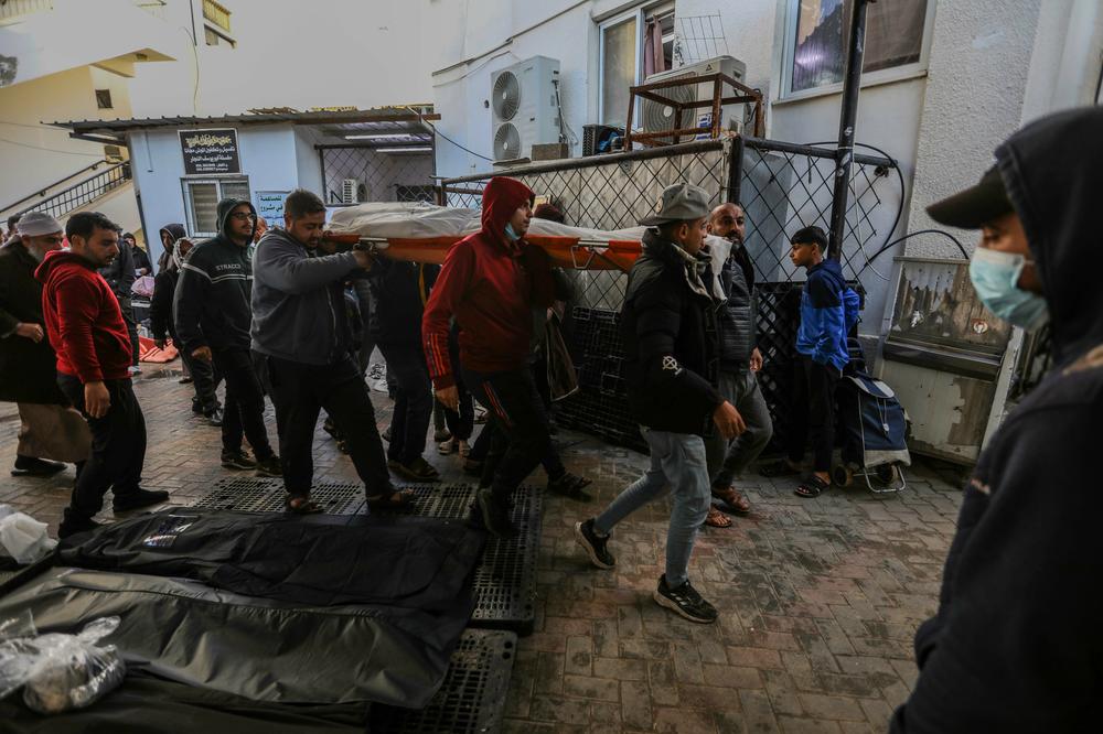 People mourn as they collect the bodies of friends and relatives killed in an airstrike on Jan. 24.