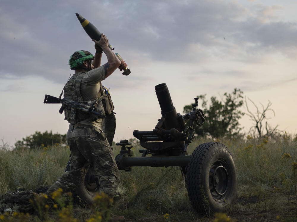 FILE - A Ukrainian serviceman of the 3rd Assault Brigade fires a 122mm mortar towards Russian positions at the front line, near Bakhmut, Donetsk region, Ukraine, Sunday, July 2, 2023. Employees from a Ukrainian arms firm conspired with defense ministry officials to embezzle almost $40 million earmarked to buy 100,000 mortar shells for the war with Russia, Ukraine's security service reported.