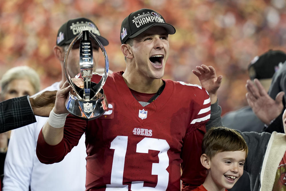San Francisco 49ers quarterback Brock Purdy celebrates with the trophy after their win against the Detroit Lions in the NFC Championship NFL football game in Santa Clara, Calif., on Sunday.