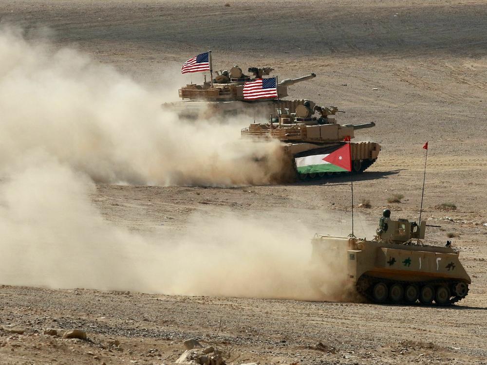 A Jordanian armored personnel carrier and U.S. tanks take part in the 