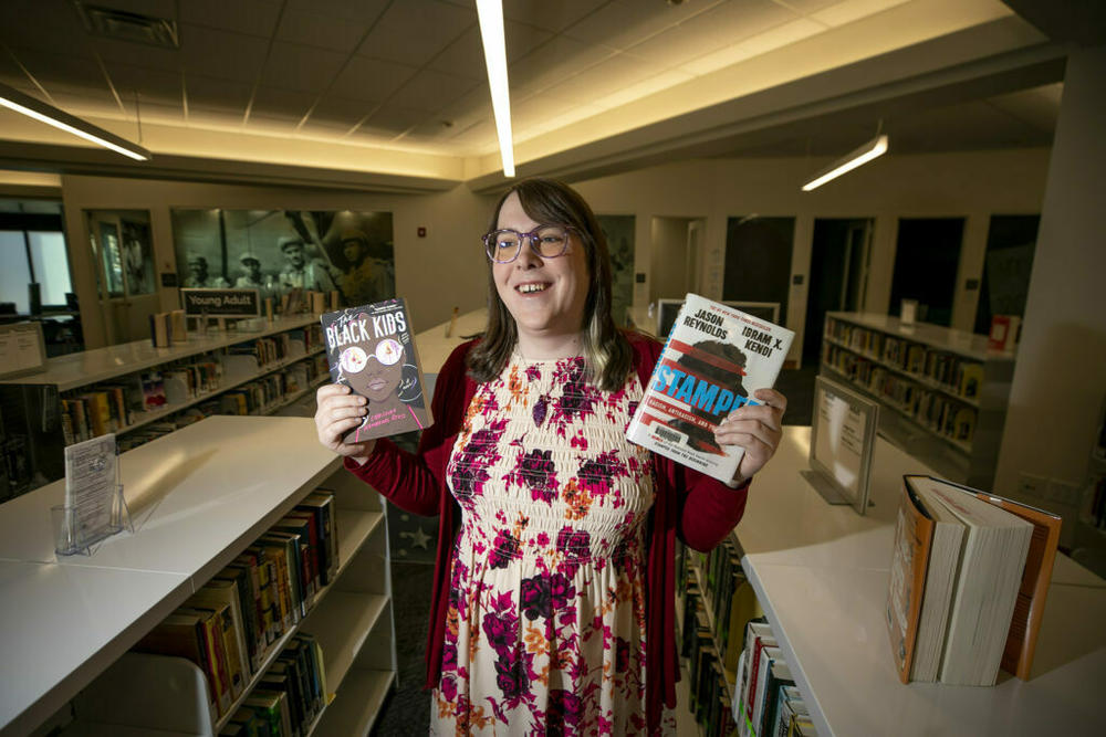 Blair-Caldwell African American Research Library teen librarian Juno Kling holds some of her favorite books. Jan. 16, 2024.