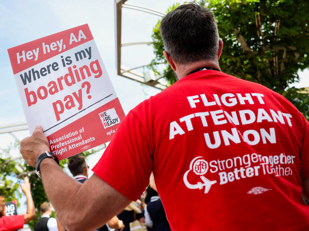 American Airlines flight attendants, represented by the Association of Professional Flight Attendants (APFA), picket outside Ronald Reagan National Airport last August in Arlington, Va.