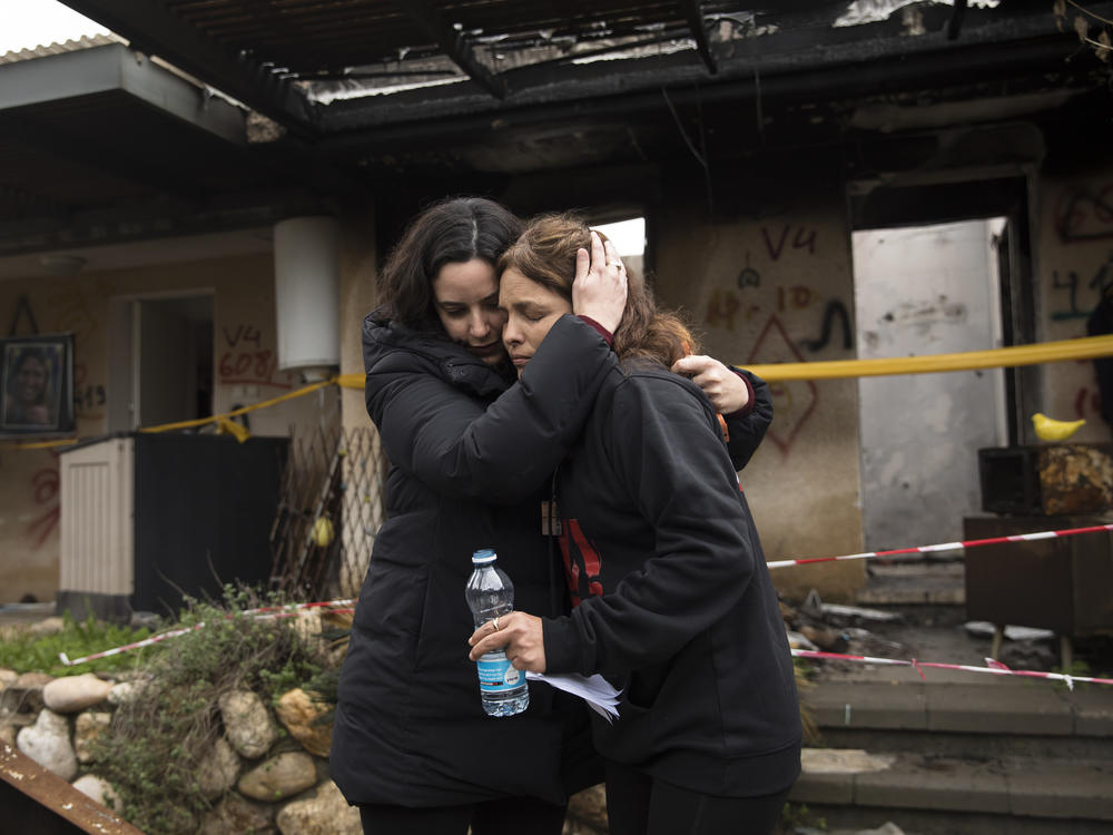 Amit Soussana (r), who was held hostage by Hamas and released hugs a friend near her house where she was kidnapped during the Oct. 7 attack on the kibbutz, on Jan. 29, 2024, in Kfar Aza, Israel. Many of the towns and kibbutzim attacked on that day remain completely evacuated, with their residents having relocated to other parts of Israel.