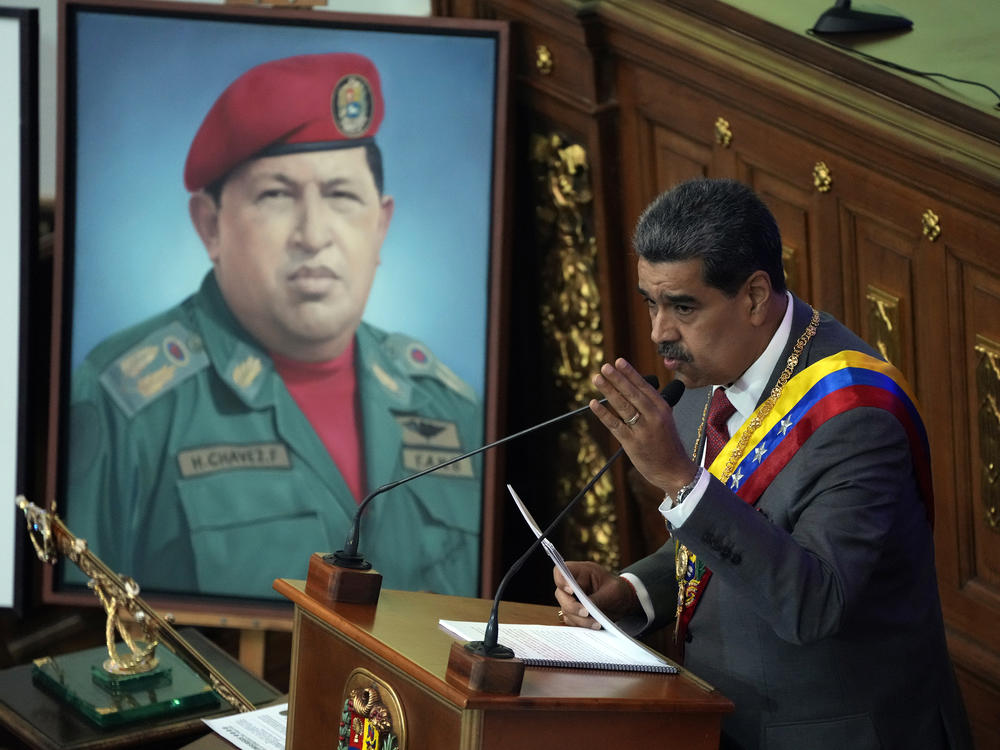 Venezuelan President Nicolás Maduro delivers his annual address at the National Assembly in Caracas, Venezuela, Jan. 15. Behind is an image of late President Hugo Chávez.