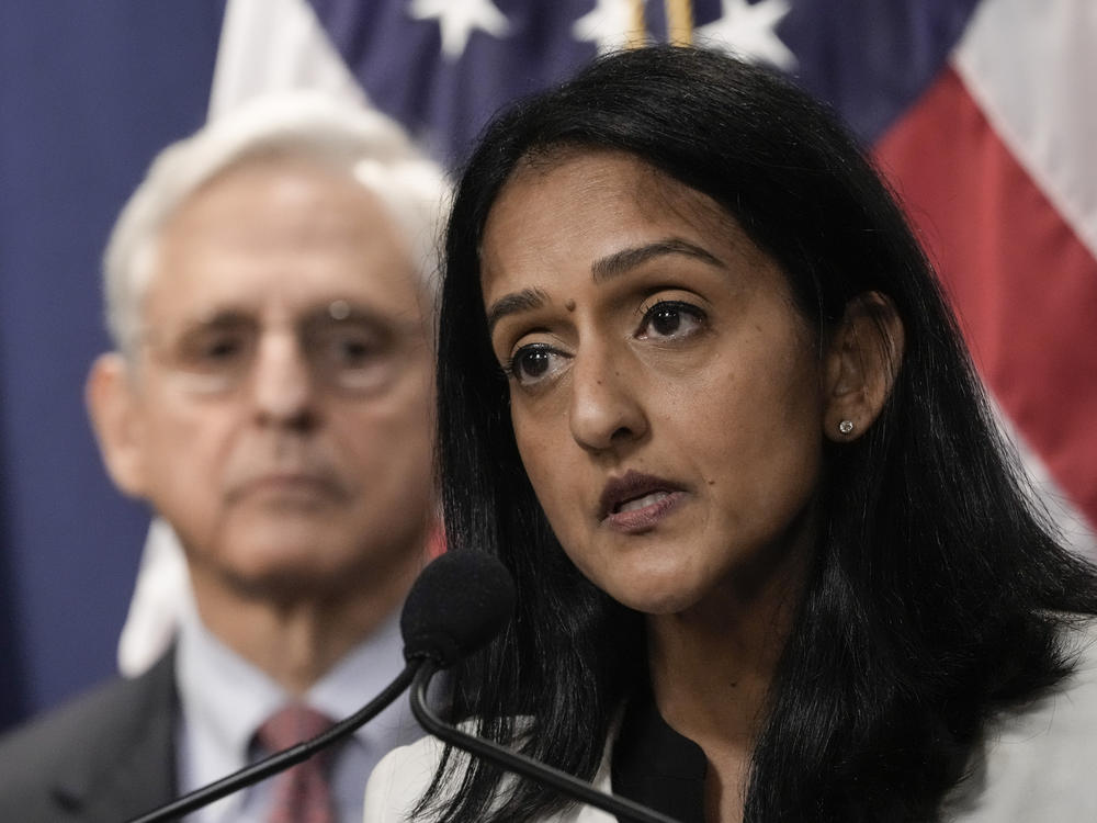 Associate Attorney General Vanita Gupta speaks during a news conference at the Justice Department on Aug. 2, 2022, as Attorney General Merrick Garland looks on.