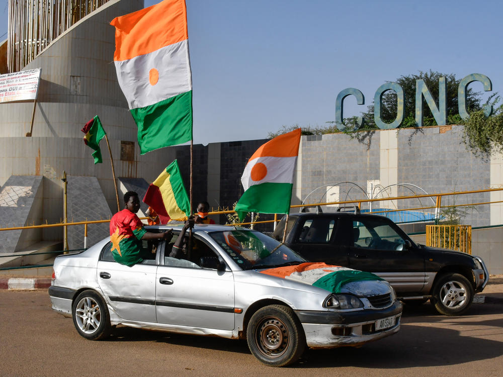 Supporters of the Alliance Of Sahel States (AES) drive with flags as they celebrate Mali, Burkina Faso and Niger leaving the Economic Community of West African States (ECOWAS) in Niamey on January 28, 2024.