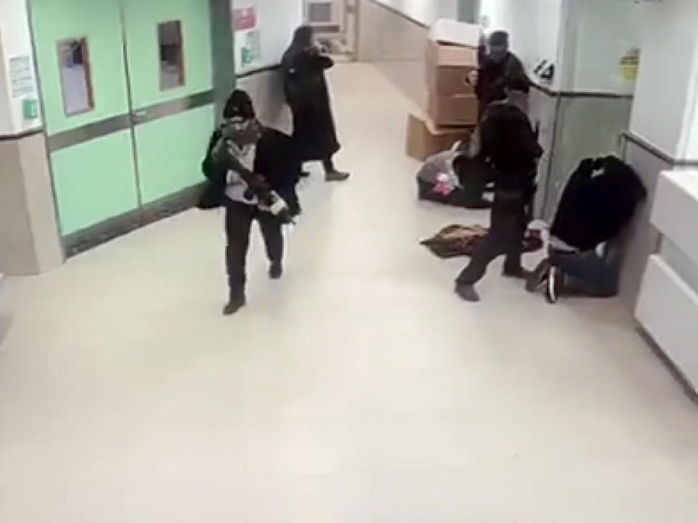A screen grab from a security camera shows what hospital staff described as Israeli forces in disguise, holding weapons, raiding the Ibn Sina Hospital in Jenin, West Bank, on Tuesday,