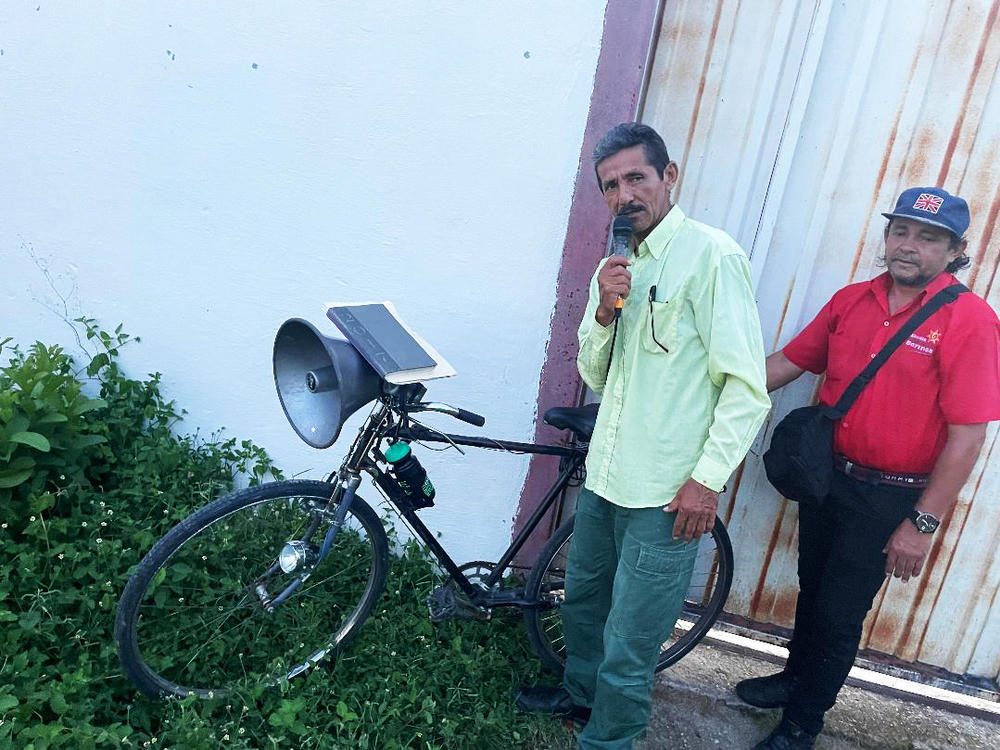 Venezuelan evangelical pastor Wenceslao Méndez draws people to his sermons from his bike using a speaker system.