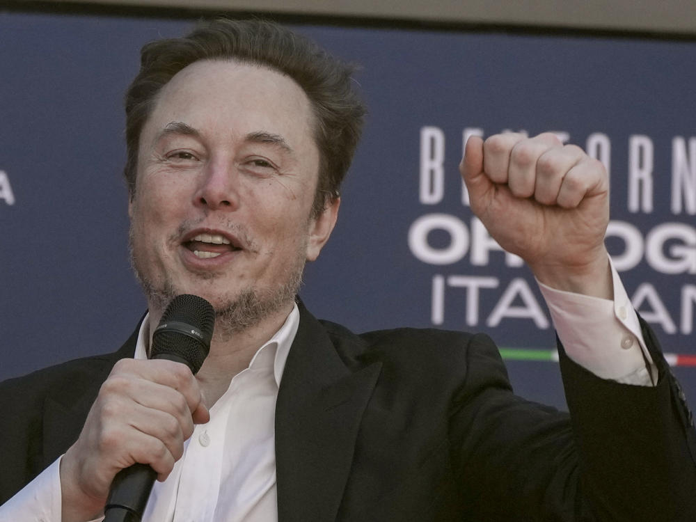 Tesla CEO Elon Musk waves as he arrives at the annual political festival Atreju, organized by the Giorgia Meloni's Brothers of Italy political party, in Rome, Dec. 16, 2023.