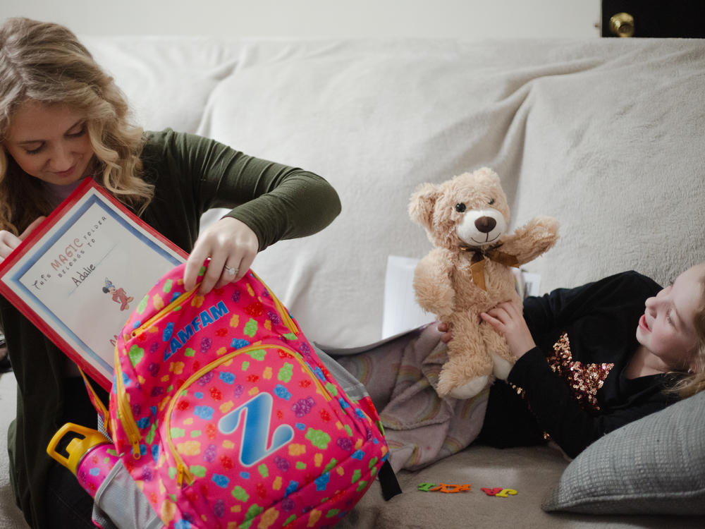 Allie Phillips, 28, discusses homework with her 6-year-old daughter, Adalie, at their home in Clarksville, Tenn.