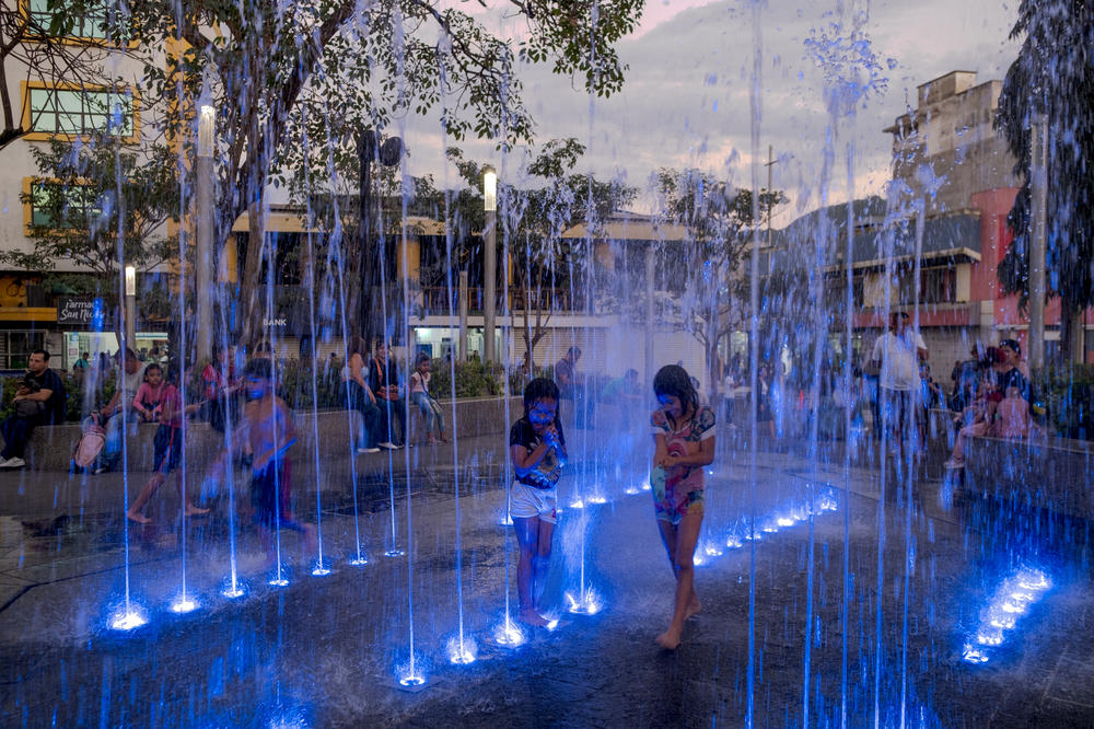 Children play in a water fountain in downtown San Salvador on January 26, 2024. For decades, downtown San Salvador was a disputed territory between the Barrio 18 gang and MS-13.
