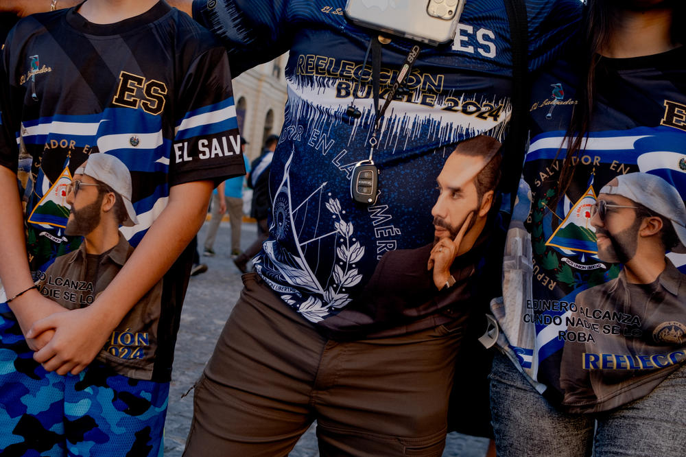 Daniel Alvarado, 13, Carlos Flores, 50, and Kimberly Alvarado, 16, wear President Bukele t-shirts in downtown San Salvador on Jan. 31. Flores has lived in the state of Virginia and Washington D.C. for the last 25 years, and he supports President Bukele's re-election because of the work he has done in terms of security and infrastructure in downtown San Salvador.