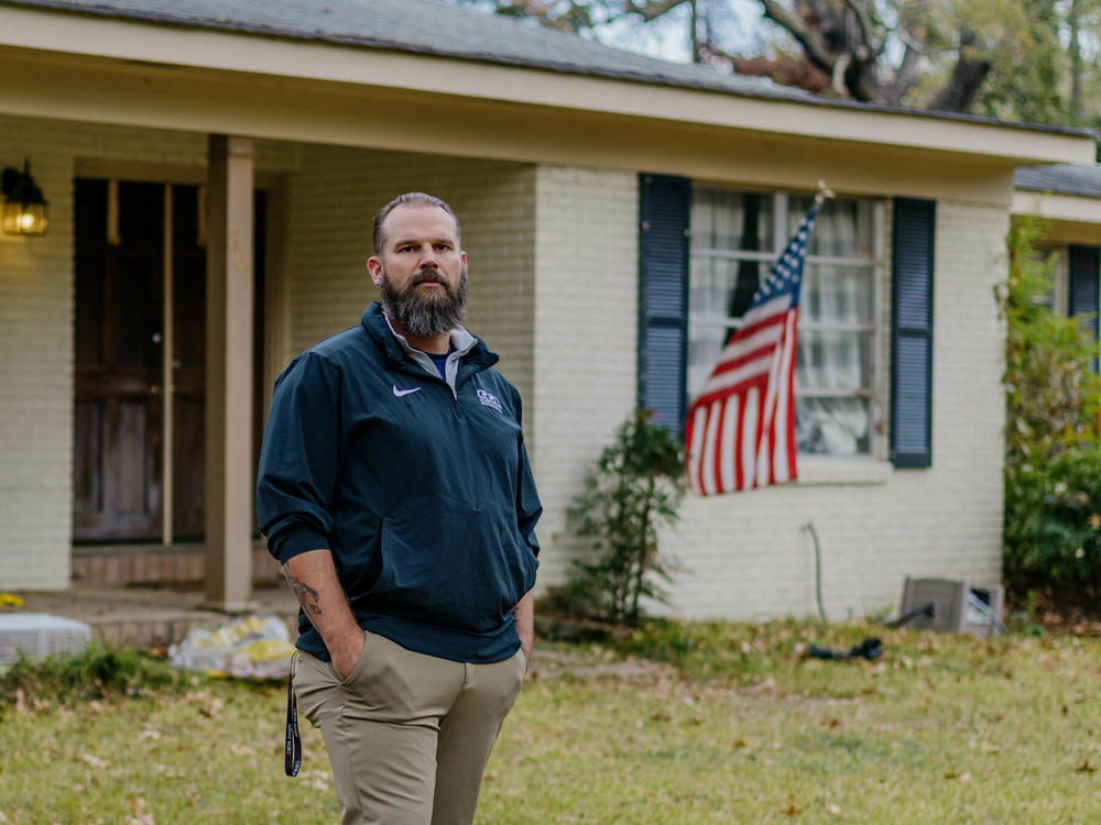 Former Marine Jason Miles stands in front of his home in Clinton, Miss. He lost a sales job during the pandemic and had to take a mortgage forbearance.