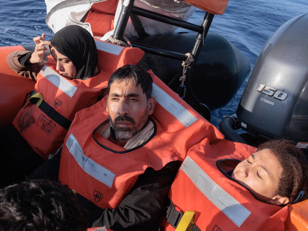 A Syrian family is brought to safety by an MSF rescue raft after being rescued Oct. 6 after a night spent in darkness on a crowded boat in the Mediterranean Sea.