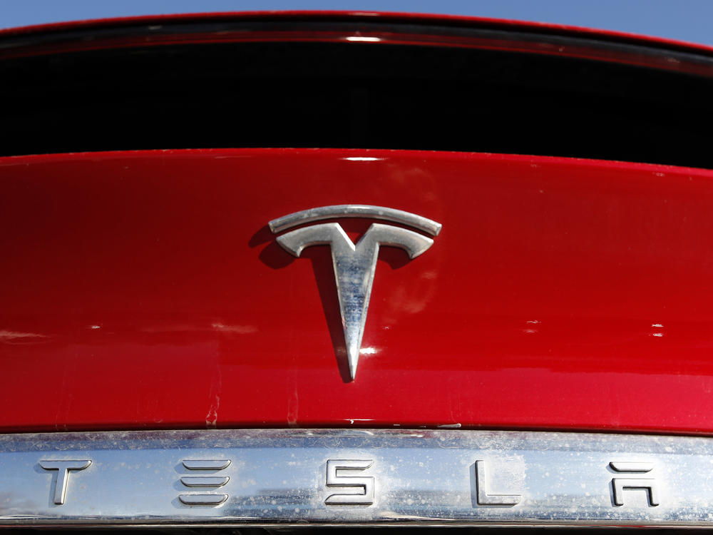 The Tesla company logo is shown in Littleton, Colo., in 2020. Tesla is recalling nearly all of the vehicles it has sold in the U.S. because some warning lights on the instrument panel are too small.