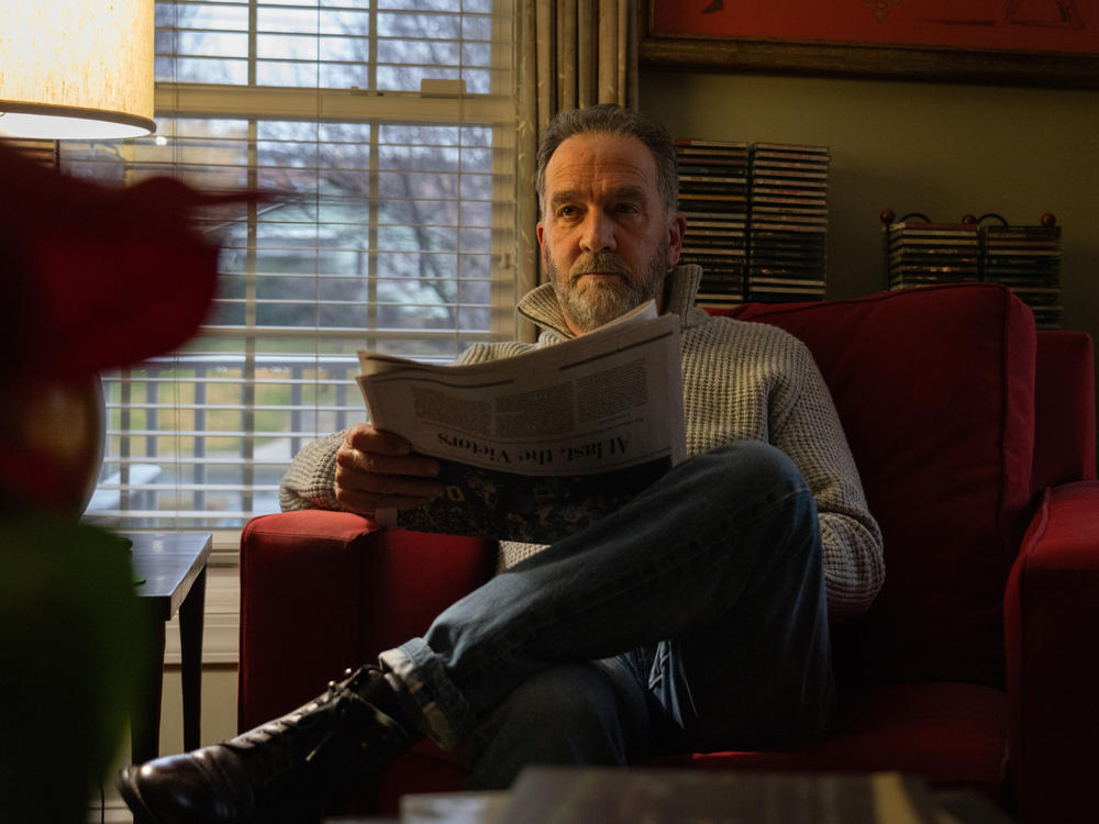 Writer George Pelecanos reads <em>The</em> <em>Washington Post</em> every morning in his home.